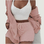 Person wearing a white fuzzy top and pink fuzzy shorts with a matching pink robe.