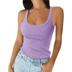 Woman wearing a purple tank top and blue jeans on a white background